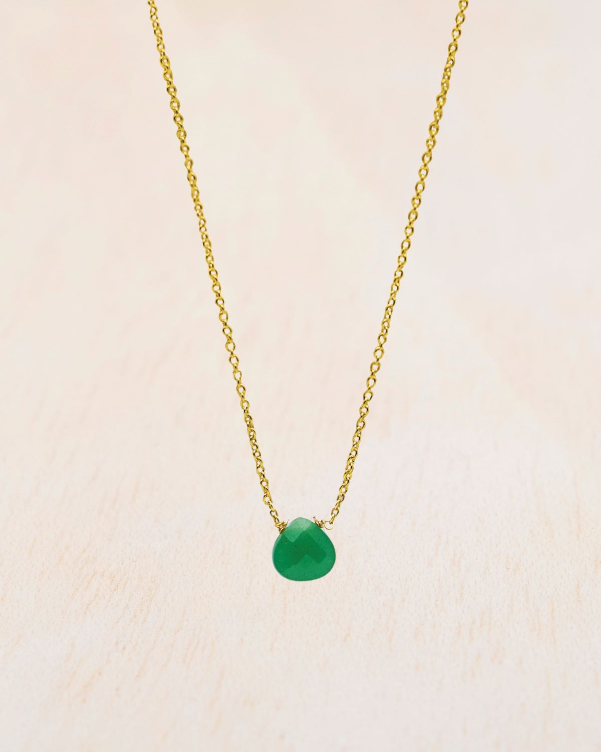 Primer plano del collar bañado en oro de 18 quilates con piedra tallada en Jade de Isla Vurma